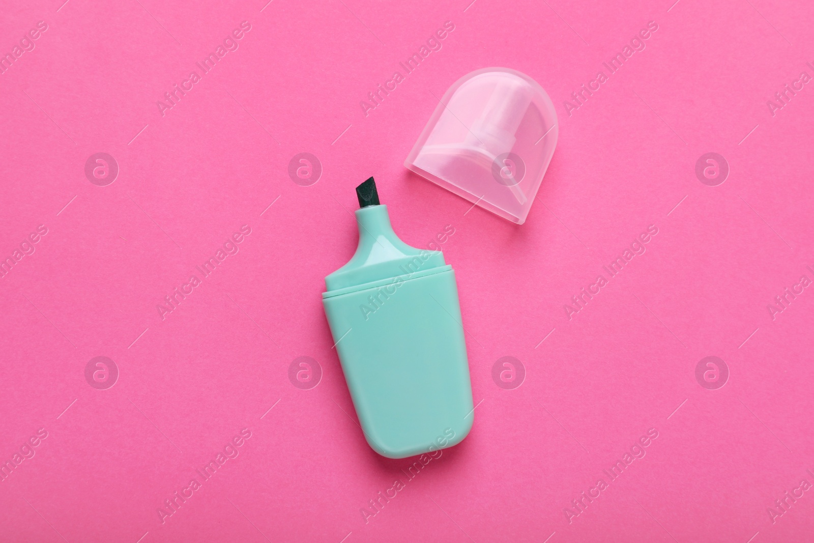 Photo of One marker with cap on pink background, top view