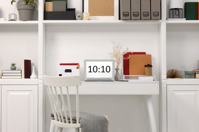 Photo of Cozy workspace with laptop on wooden desk at home