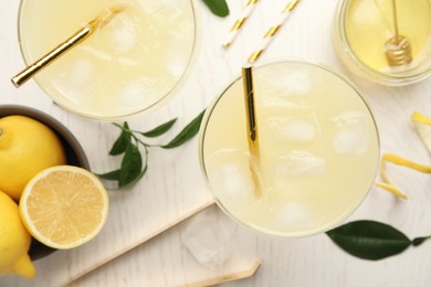 Photo of Delicious bee's knees cocktails and ingredients on white wooden table, flat lay