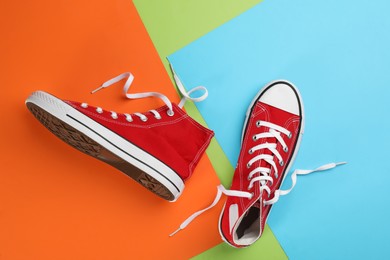 Photo of Stylish sneakers on color background, flat lay