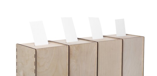 Wooden ballot boxes with votes isolated on white