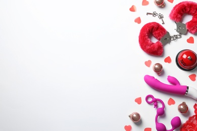 Set of different sex toys, red hearts and Christmas balls on white background, top view
