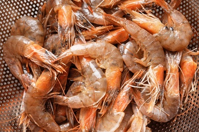 Photo of Colander with fresh shrimps, closeup