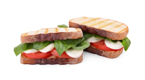 Photo of Delicious Caprese sandwiches with mozzarella, tomatoes and basil isolated on white