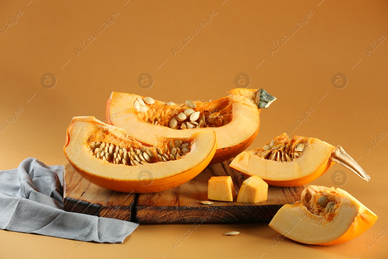 Photo of Cut fresh ripe pumpkin on orange background