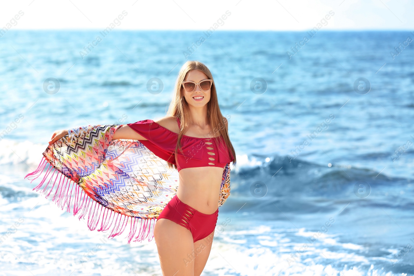 Photo of Attractive young woman in beautiful bikini swimsuit on beach