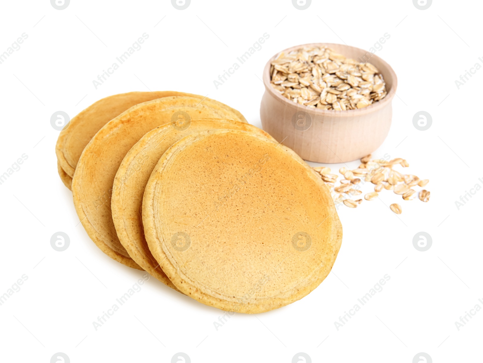 Photo of Tasty oatmeal pancakes and flakes on white background