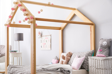 Photo of Stylish child room interior with comfortable bed