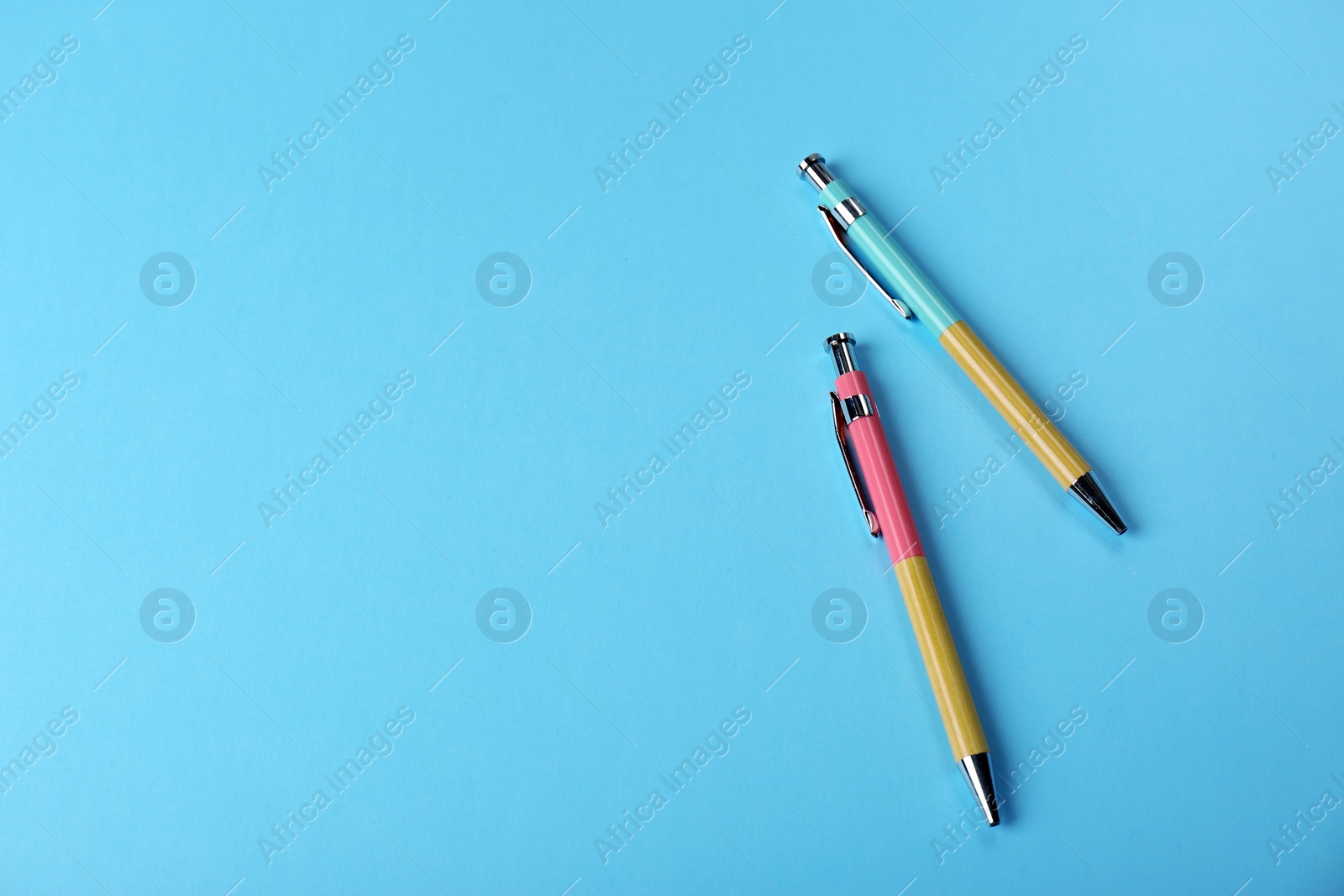 Photo of Bright pens on color background, flat lay. Space for text