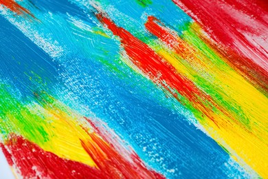 Strokes of colorful acrylic paints on canvas, closeup