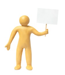 Photo of Human figure made of yellow plasticine holding blank sign isolated on white