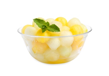 Photo of Glass bowl of melon balls with mint on white background