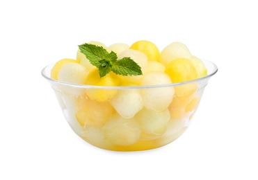 Glass bowl of melon balls with mint on white background