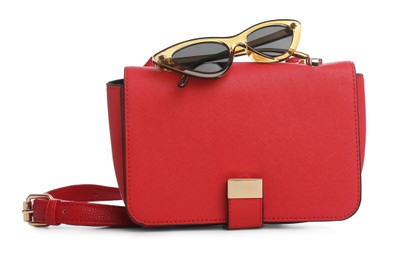 Stylish woman's bag and sunglasses isolated on white