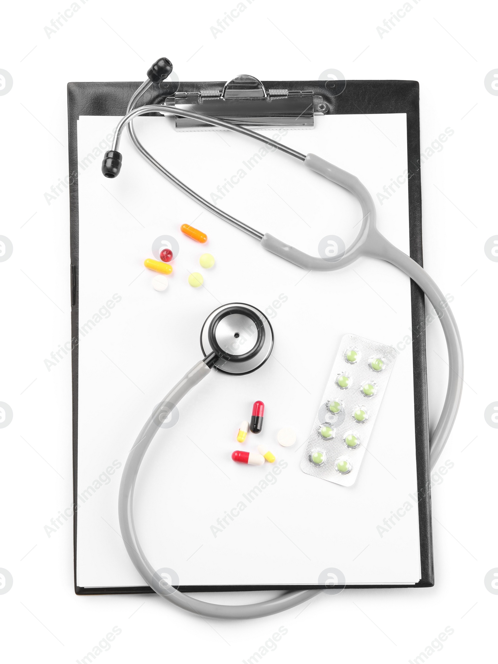 Photo of Stethoscope, pills and clipboard isolated on white, top view. Medical tool