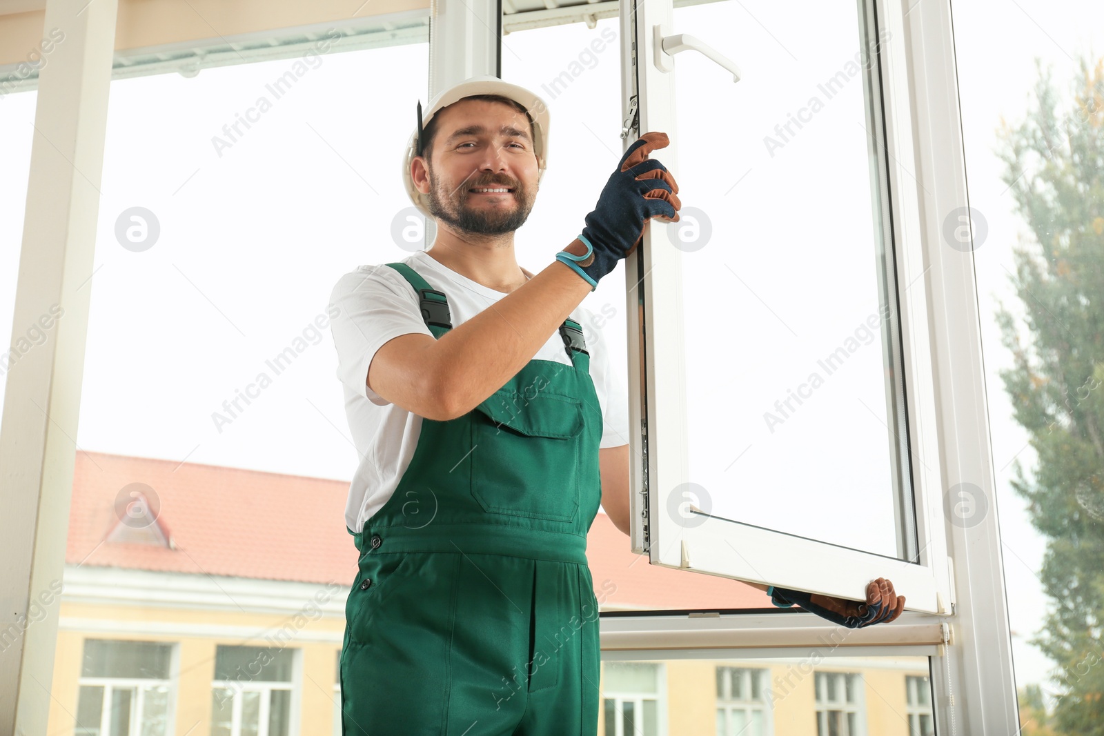 Photo of Construction worker installing new window in house