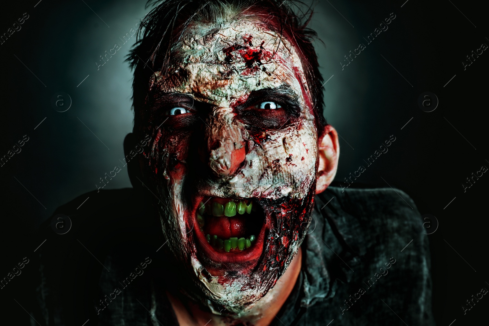 Photo of Scary zombie on dark background, closeup. Halloween monster