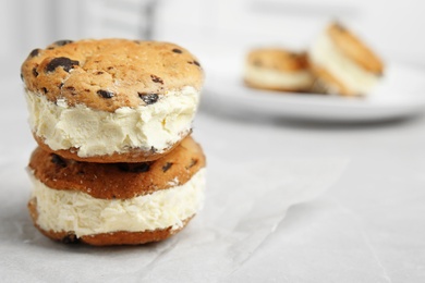 Photo of Sweet delicious ice cream cookie sandwiches on table, space for text