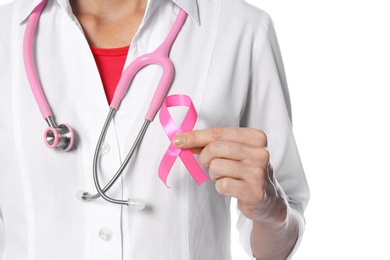 Female doctor with pink ribbon and stethoscope on white background, closeup. Breast cancer concept