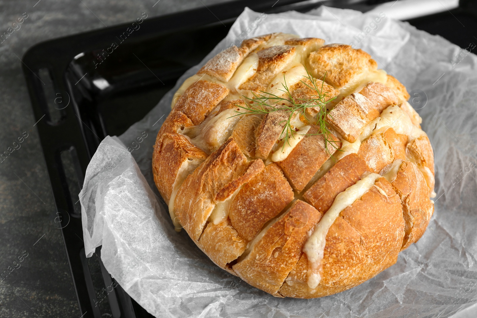 Photo of Freshly baked bread with tofu cheese on table, closeup