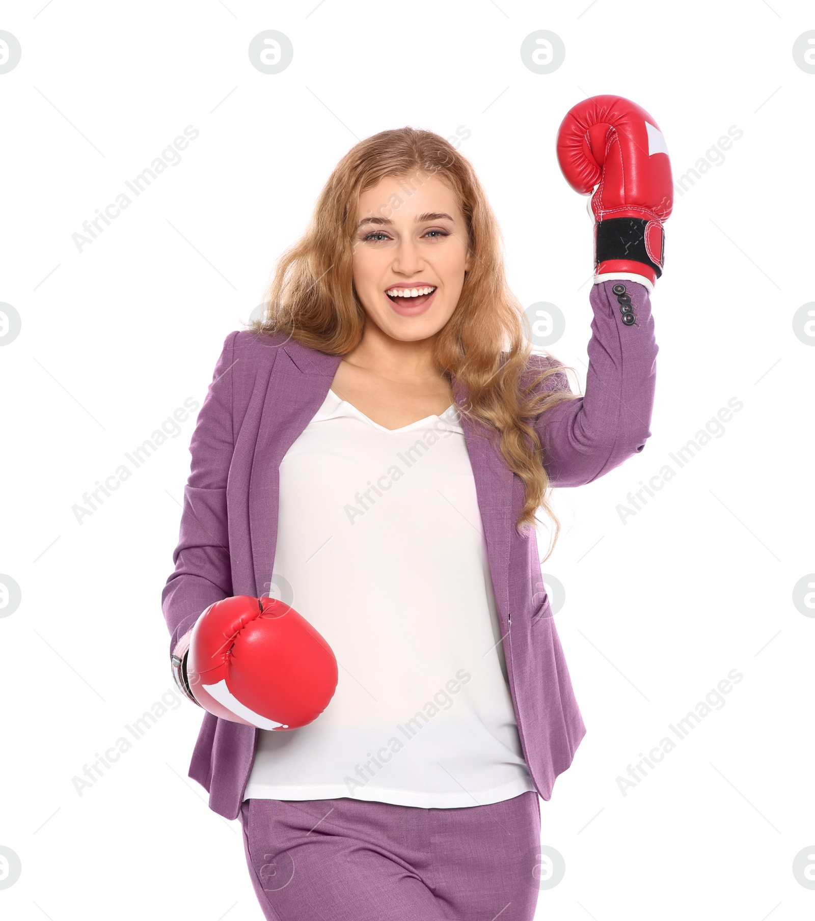 Photo of Happy young businesswoman with boxing gloves celebrating victory on white background