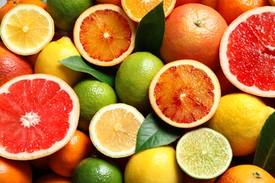 Photo of Different citrus fruits as background, top view