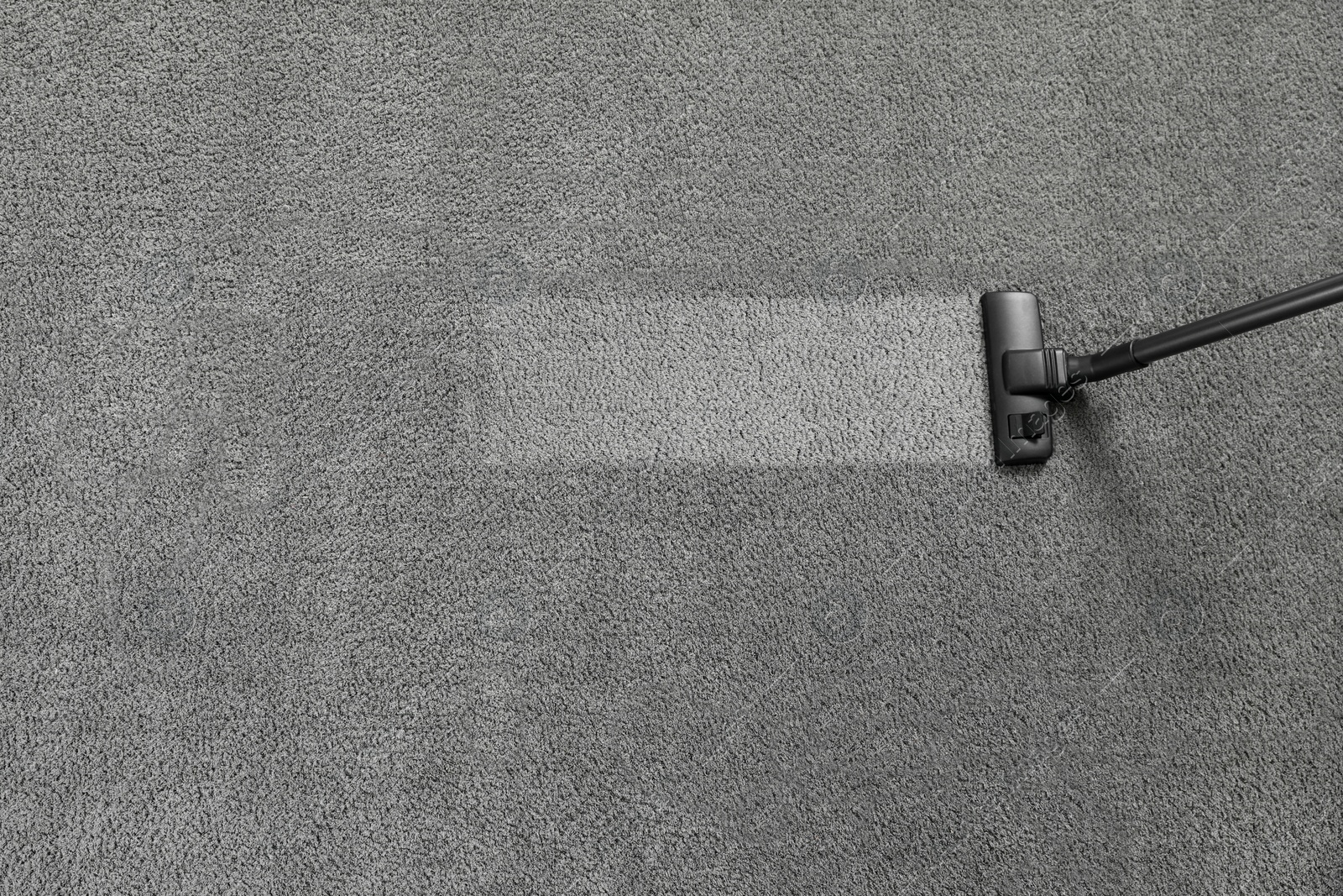 Photo of Vacuuming grey carpet. Clean area after using device, top view. Space for text