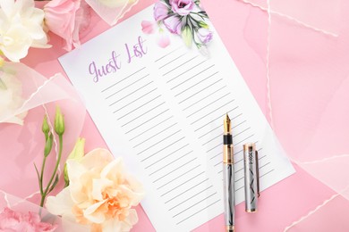 Photo of Guest list, pen, tulle fabric and beautiful flowers on pink background, flat lay. Space for text