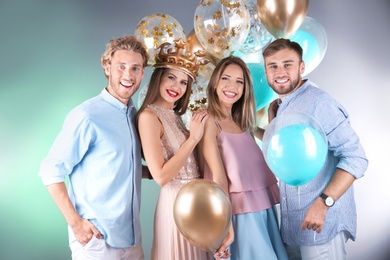 Friends with air balloons on color background