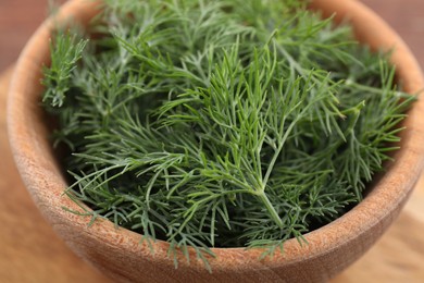 Photo of Bowl of fresh dill on table, closeup