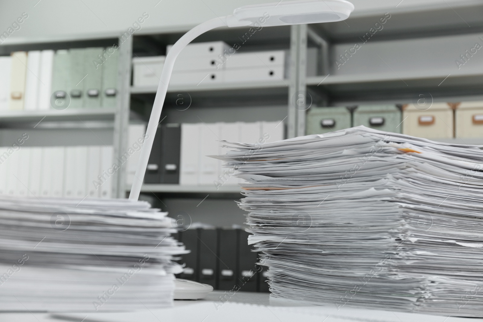 Photo of Stacks of documents on table in office