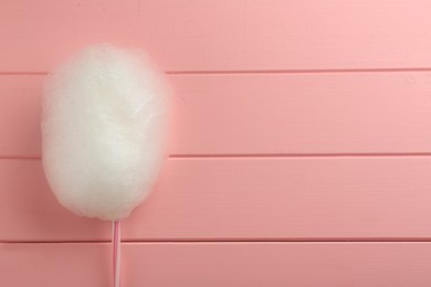 One sweet cotton candy on pink wooden table, top view. Space for text