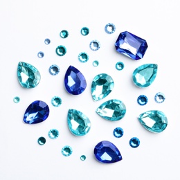 Image of Different beautiful gemstones on white background, top view