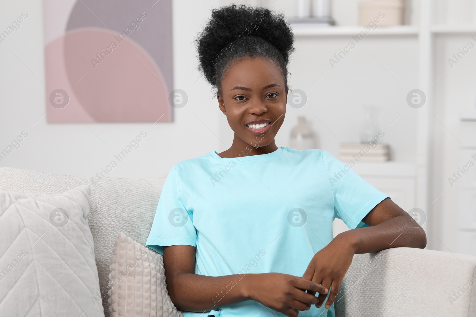 Photo of Beautiful young woman on sofa at home