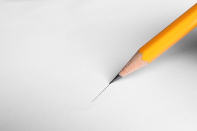 Photo of One sharp graphite pencil drawing on white background, above view. Space for text