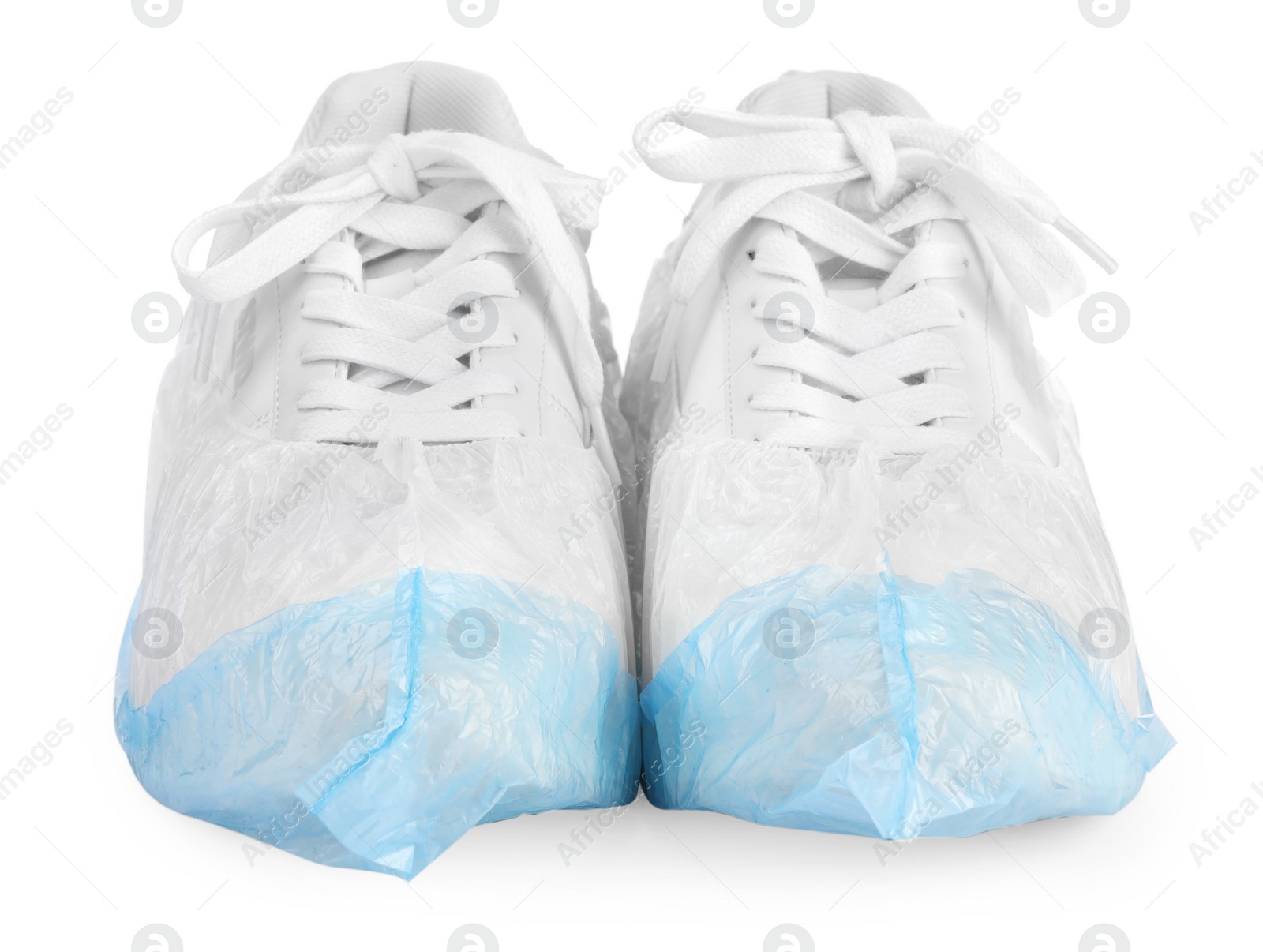 Photo of Sneakers in shoe covers isolated on white