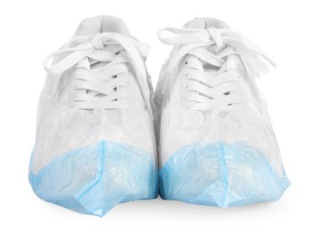 Photo of Sneakers in shoe covers isolated on white