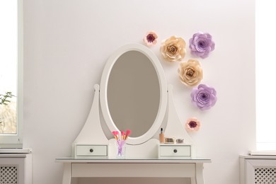 Stylish room interior with floral decor and dressing table