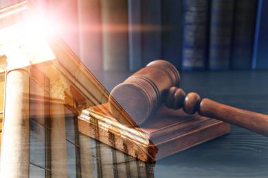 Image of Law protection. Double exposure of wooden gavel and court building