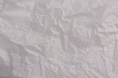 Photo of Texture of crumpled parchment paper as background, top view