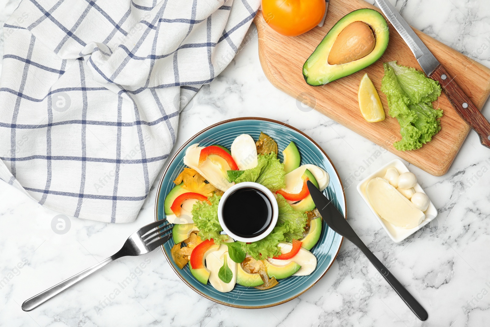 Photo of Fresh vegetable salad with balsamic vinegar served on marble table, top view