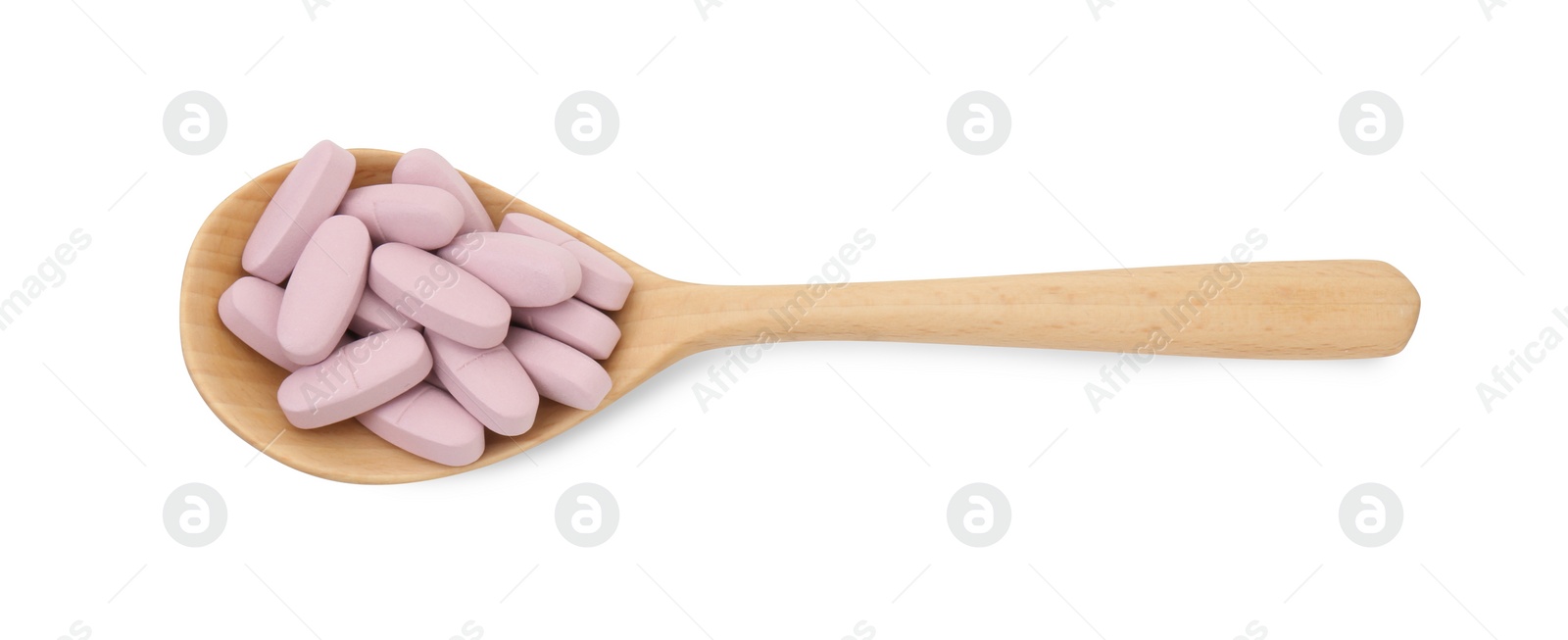 Photo of Vitamin pills in wooden spoon isolated on white, top view. Health supplement