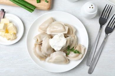 Flat lay composition with tasty dumplings served on white table