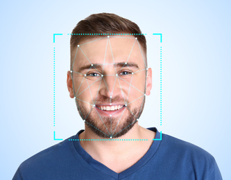 Image of Facial recognition system. Young man with scanner frame and digital biometric grid on light background