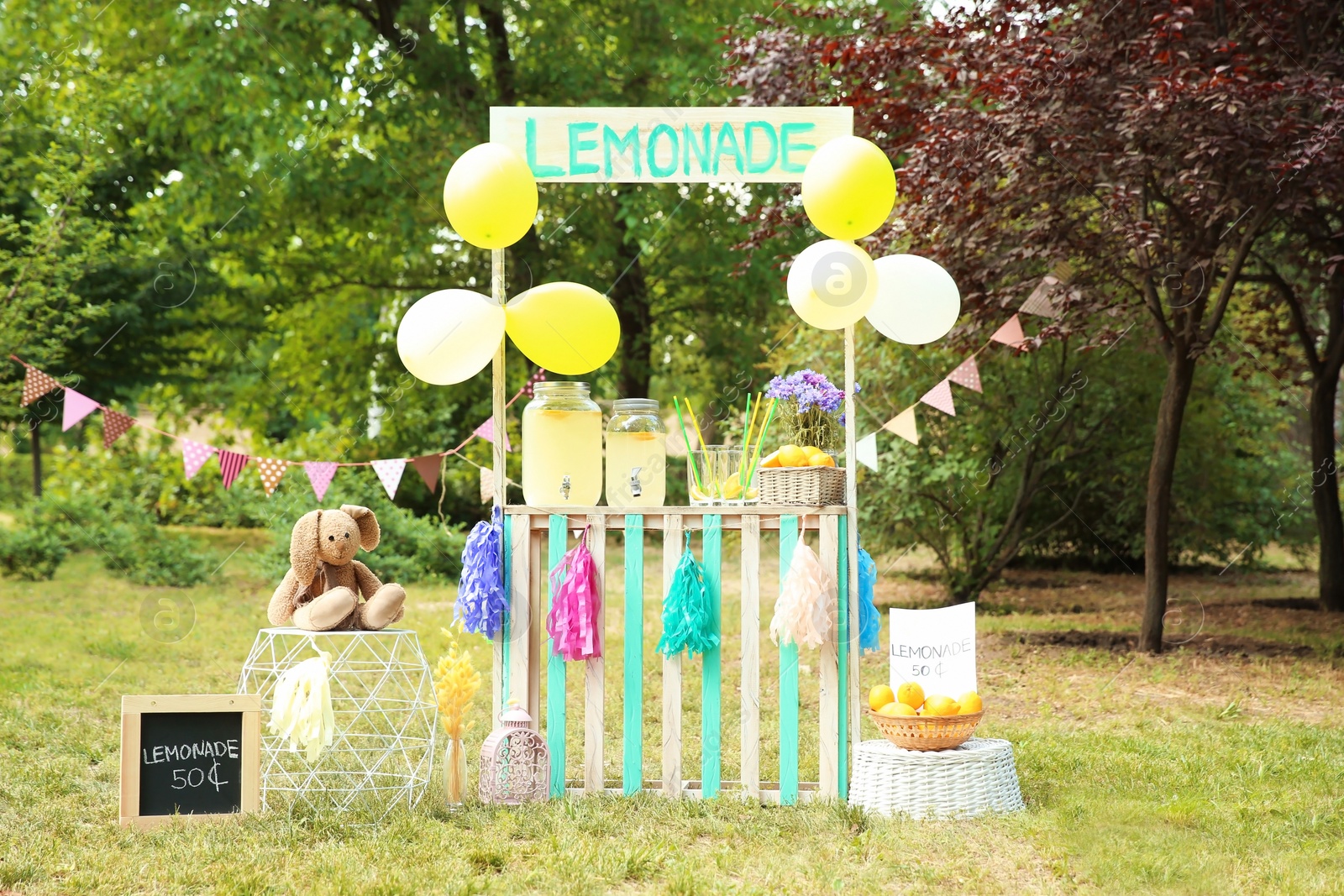 Photo of Decorated lemonade stand with glassware in park