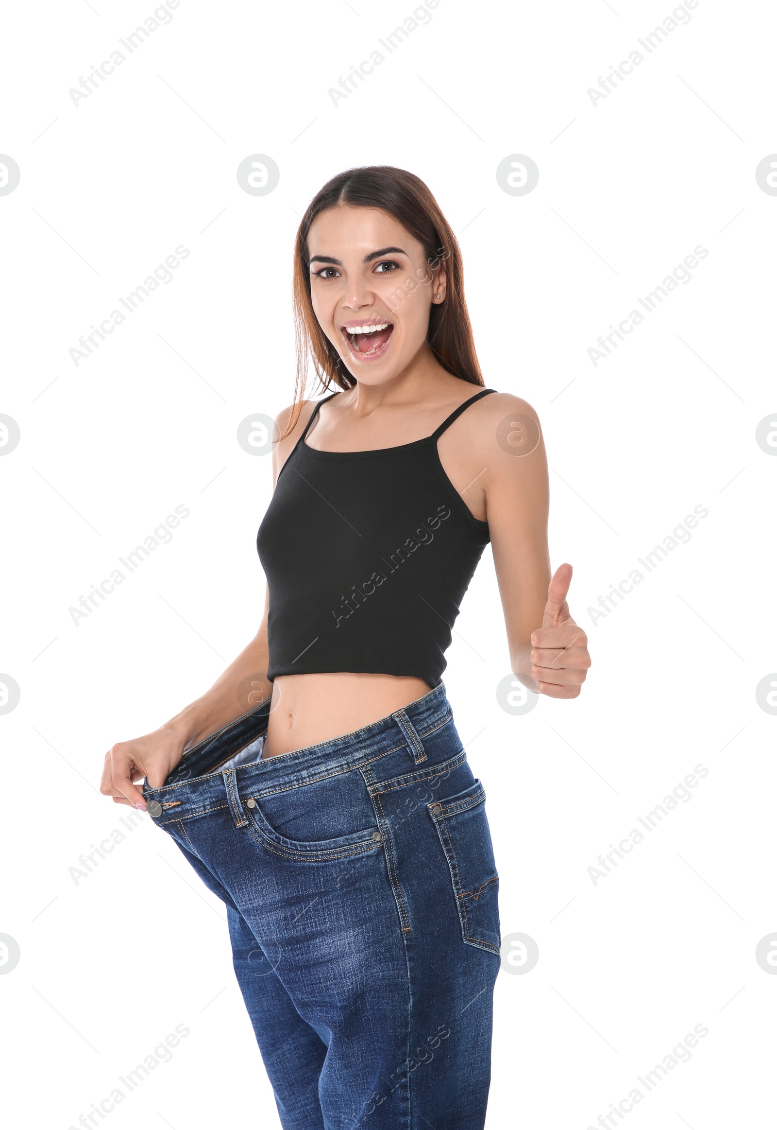 Photo of Slim woman in oversized jeans on white background. Weight loss