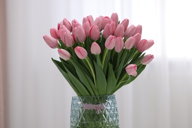 Bouquet of beautiful pink tulips in vase indoors