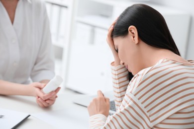 Young woman suffering from migraine in hospital