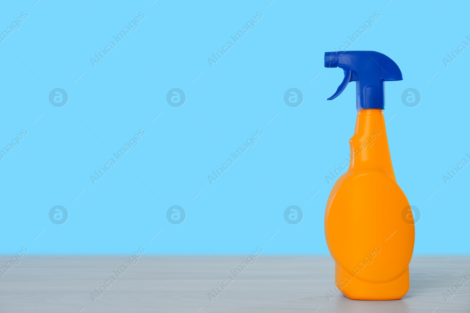 Photo of Bottle of cleaning product on light table. Space for text