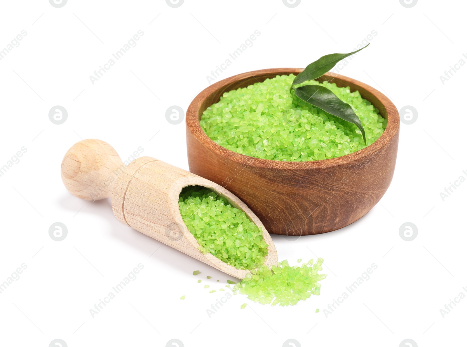 Photo of Green sea salt in bowl, scoop and leaves isolated on white